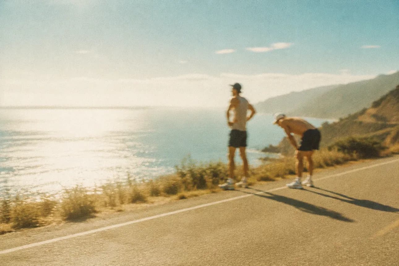 Two runners overlooking the coast after a training session
